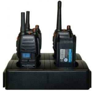 A pair of walkie talkies on top of a charging station.