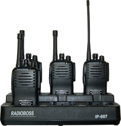 A group of four radios sitting on top of a black stand.