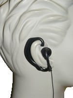 A white statue with black headphones hanging from it's ear.