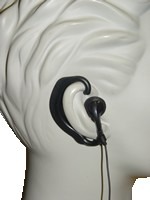 A white statue with some black headphones on it