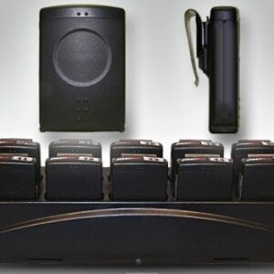 A black speaker system sitting next to a wall.
