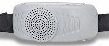 A white speaker with black dots on it.