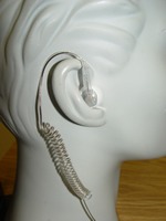 A white ear with a wire attached to it.