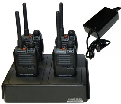 A group of four radios sitting on top of a table.