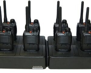 A group of walkie talkies sitting on top of two black stands.