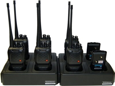 Two radios are sitting on a stand and one is in the other.