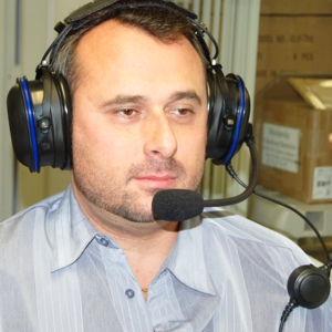 A man wearing headphones and holding a microphone.
